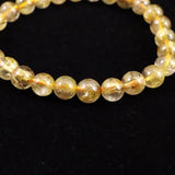 ゴールドタイチンルチルクォーツ 3A 7mm玉ブレスレット 13.1g (ID:55680)